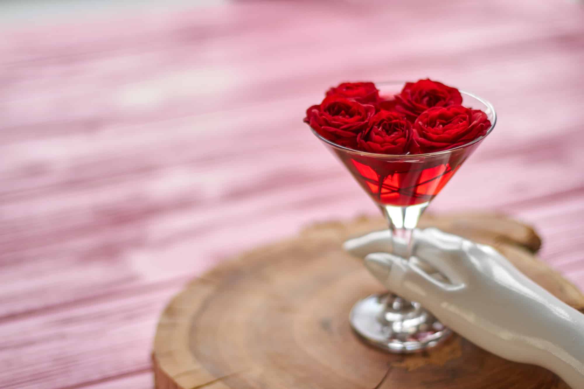 Mannequins hand with cocktail of red roses.